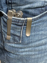 Titanium pocket clip with magnets and hub screw.